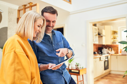 Couple looking at tablet together and planning at home