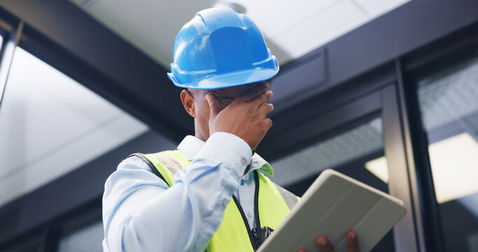 Man, contractor and headache with tablet for maintenance issue, building mistake or compliance. Technician, engineer or migraine with technology or hard hat for safety crisis or deadline in workplace