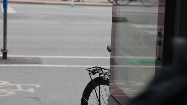 Stockholm, Sweden Bicyclists on a bike path in the Sodermalm district are reflected in an advertising display window. 
