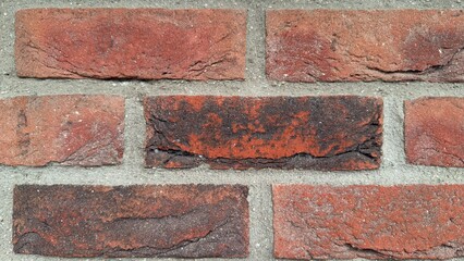 Fototapeta premium Macro shot of red clinker brick texture, detailed clay brickwork wall background