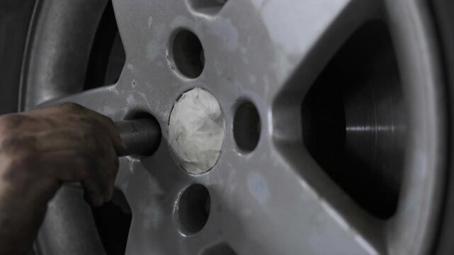 Close Up of Mechanic Hand Inserting a Socket Extension Tool into Car Wheel Rim to Fix Lug Nut