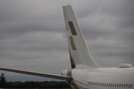 Airplane tail fin and satellite wi-fi antenna on fuselage.