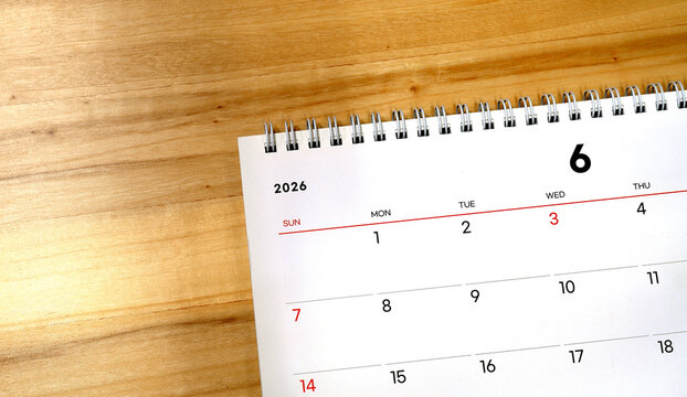 2026 calendar, June 2026 desk calendar on a wooden desk, 2026 New Year's plans.