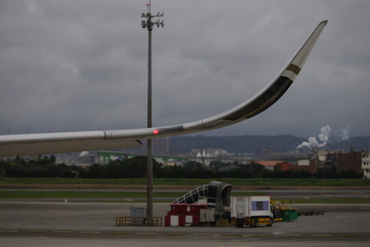 A winglet with red navigation light on an airplane wing.