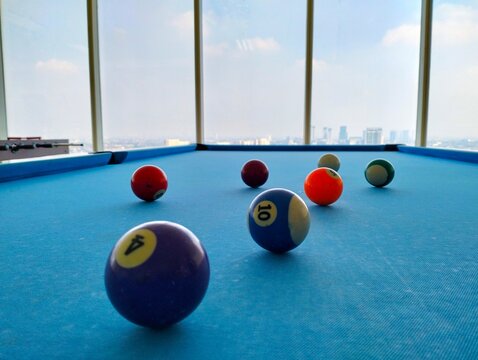 blue billiard table with balls on it