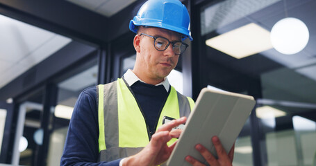 Man, contractor or office with tablet for building maintenance, safety check or security. Male person, technician or engineer with technology or hard hat for installation or checklist in workplace © peopleimages.com