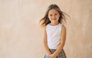Fototapeta premium The girl smiling softly with windblown hair wearing white tanktop and plaid skirt