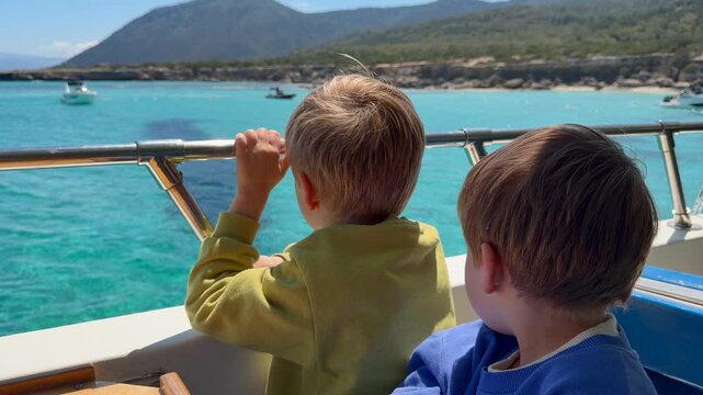 Kids observing coastline from boat highlight exploration and outdoor education concept for business visuals. Children imagery enhances travel campaigns, learning materials, family lifestyle promotion