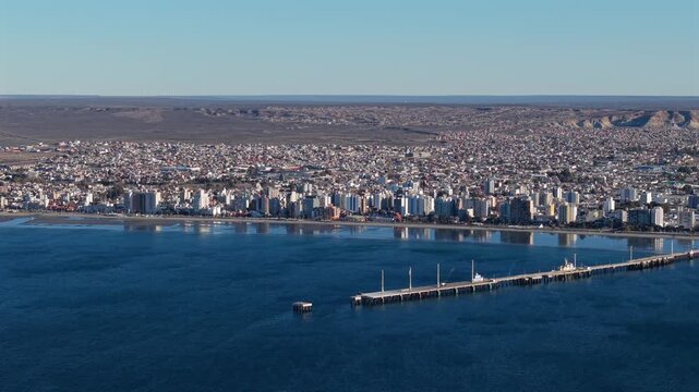 Aerial Establishing Tilt Down of Puerto Madryn City and Piedra Buena Pier Argentina