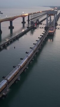Vertical Aerial Night View of Train Crossing Pamban Bridge Tamil Nadu India