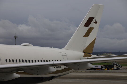 Vertical tail fin and fuselage of a Starlux Airlines airplane at airport.