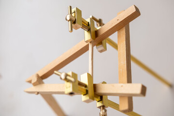 Fototapeta premium miniature wooden easel brass hardware adjustment screws crafting tools art supply manufacturing workshop precision woodworking handmade model display stand creative hobby project, dollhouse designers