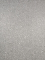 Fototapeta premium a natural gray stone or concrete surface texture with fine granular details and subtle mineral deposits scattered across the surface. 