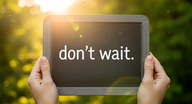 Hands holding a chalkboard with the text dont wait written on it