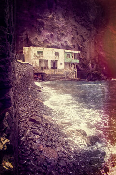 Tenerife, Canary Islands, Spain: a dilapidated house on the pebble and black-sand beach of Playa de Los Roques in Los Roques de Fasnia coastal village 