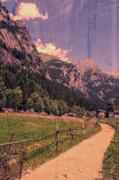 Sondrio, Italy, Europe: larches and rocks in the Val di Mello, green valley surrounded by granite mountains and forest trees, renamed the little italian Yosemite Valley by nature lovers