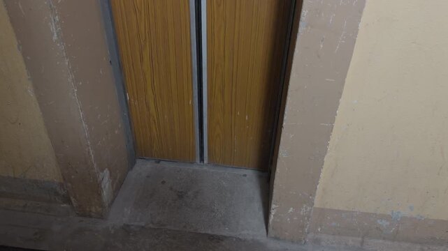 Old lift door with rust. Worn and tarnished elevator frame amid crumbling walls and deserted building ambiance