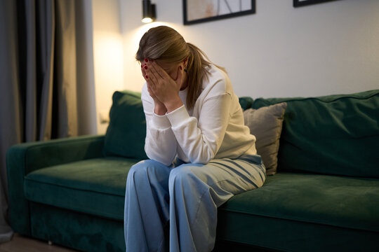 Silent moment of emotional pain on the sofa