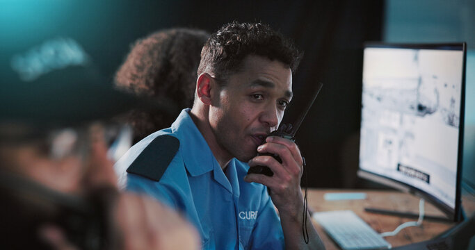 Man, security officer or night with radio for safety measure or protection in control room. Male person, guard or monitoring with signal response or cctv footage for crime alert or detection service