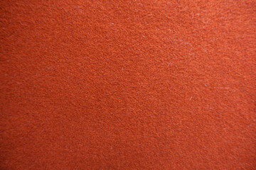 Fototapeta premium Texture of simple reddish orange felt fabric