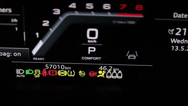Many different car dashboard lights with warning lamps illuminated. Light symbol that pops up on dashboard when something goes wrong with the engine. Close up shot of hybrid car instrument panel