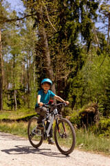 Fototapeta premium Happy children, boys, riding bikes together in a beautiful czech ruralside summer time