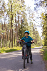 Naklejka premium Happy children, boys, riding bikes together in a beautiful czech ruralside summer time
