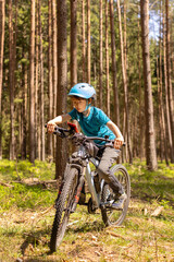 Fototapeta premium Happy children, boys, riding bikes together in a beautiful czech ruralside summer time