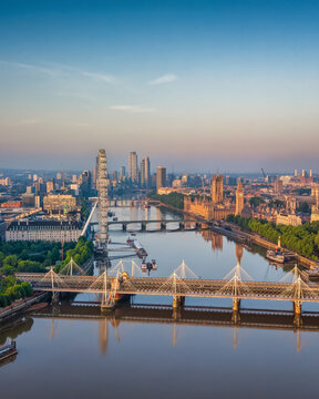 Panoramic aerial view of the skyline of London, England, with Southbank and Embankment, Westminster Palace back to Nine Elms during summer sunrise