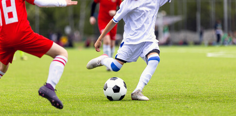 Junior Soccer Player Dribbling Ball on Green Turf During Solo Training Session - Youth Football...