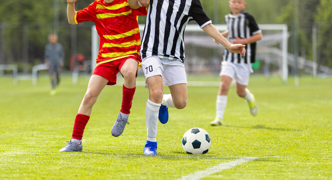 Soccer Education for Young Boys. Physical Education Class for School Children. Young Coach With Kids in Team on Training Unit. Youth Team Coach Training School Boys in Football Soccer