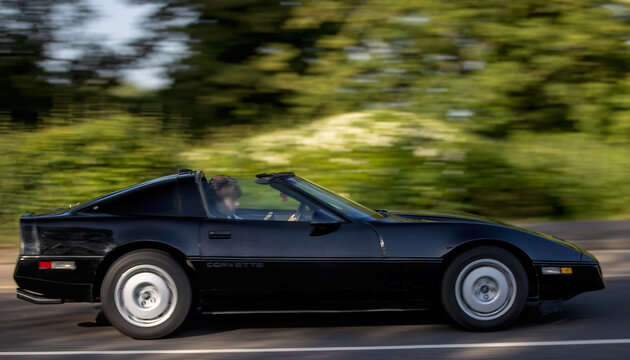 Milton Keynes,Bucks,UK - May 25th 2026: 1985 black Chevrolet Corvette American classic  car driving on a British road