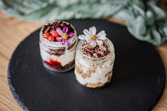 Elegant dessert cups beautifully arranged on a table for a wedding reception or special event. Sweet treats with stylish presentation, perfect for catering, celebrations, and parties.