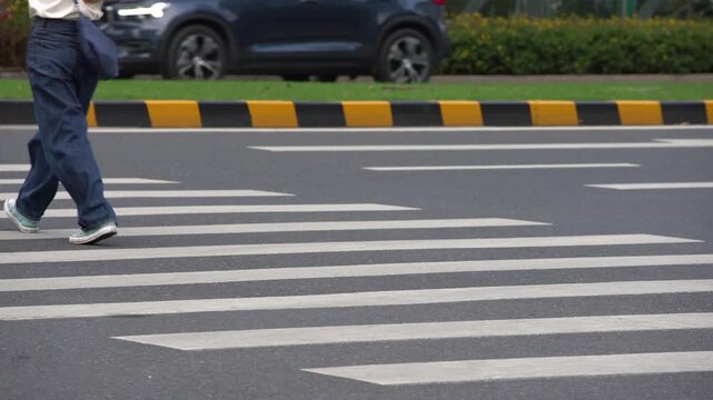 Pedestrian Walking Across Urban Zebra Crossing