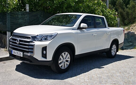 White SsangYong Musso pickup truck parked outdoors on pavement