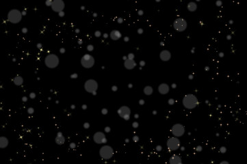 Golden sparkling stars and soft bokeh lights on black background © Ольга