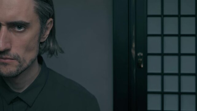 Beautiful young yakuza man serious strength confidence indoor Japanese setting with expressive emotions in a minimalistic backdrop and soft artificial lighting