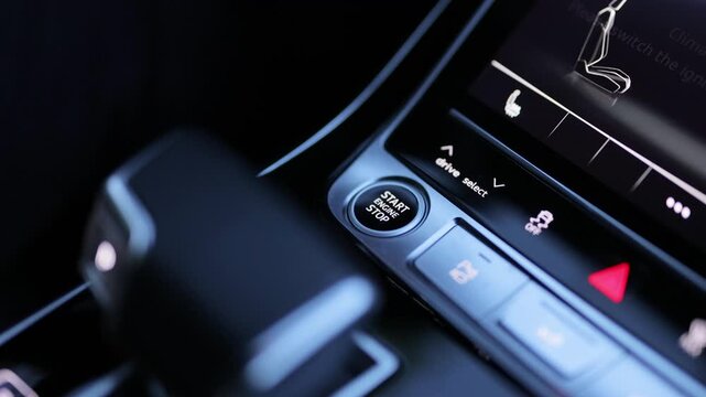 Pushing start stop Button to start keyless ignition hybrid car electro engine. Starting car engine. Button to start the car engine. Pressing Stand By Power Button To Turn On and Off the Electric Car .
