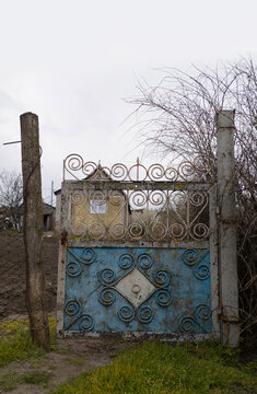 Old metal gate at rural village house entrance
