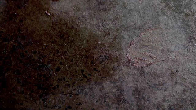 Old baking sheet texture. Used oven tray with burnt grease stains. Dark metal surface. Rotation