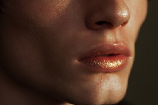Beauty edit close crop on male lips and philtrum with glossy highlight for cosmetic banner and product design