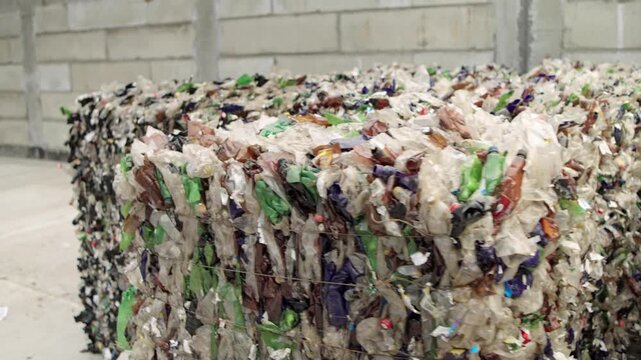 Pressed plastic bottles. Environment. Industry. Landfill of pressed plastic bottles and their recycling. Ecology. Recycling of secondary raw materials.