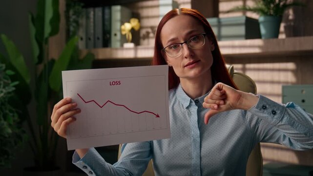Upset Caucasian business woman holding loss chart document thumb down indoor office frustrated businesswoman female saleswoman showing bad results graph decline crisis bankruptcy crypto finance report
