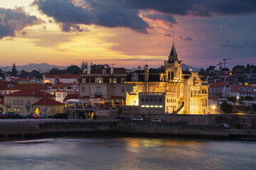 Fototapeta premium Sunset view of Cascais. Water reflecting evening light. Palácio Seixas and Santa Marta waterfront.