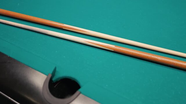 Closeup of billiard stick details. Highresolution image showcasing textured pool cues with studio lighting