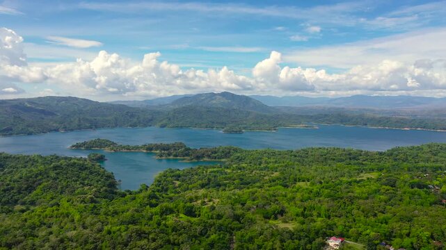Blue Pantabangan Lake among the green mountains covered with green forests. Philippines, Luzon.