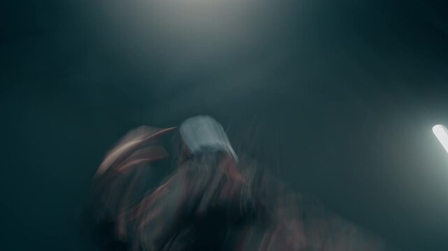 Dynamic urban dance performance shot of young woman moving energetically with frantic blurred effect and stylized cinematic distortion, copy space