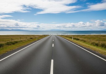 Fototapeta premium Empty road stretching into horizon under blue sky
