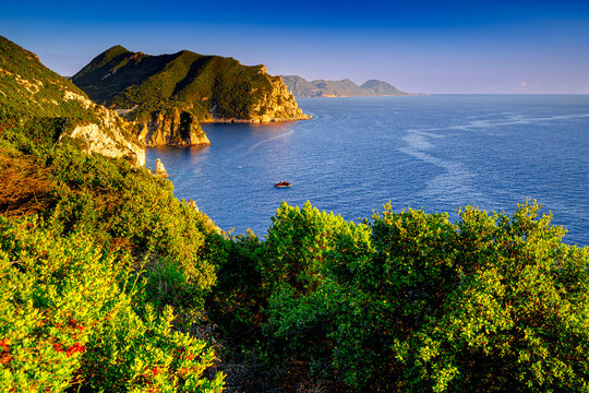 Cliffs on coast Corfu during a sunset, Gyali beach, Ionian Sea. Landscape of popular holiday island in Greece.