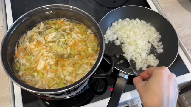 white weekday cook stirs chunky vegetable soup while sauting diced onion in adjacent pan, wooden spoon movement, steam rising, practical midweek meal prep with vibrant carrot and celery pieces